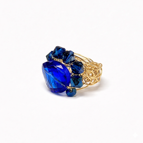 Sapphire blue cocktail ring mounted on gold wrire band