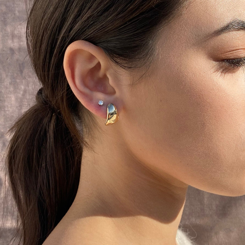 gold organic shaped huggie earrings. Sculptural studs by desideri design