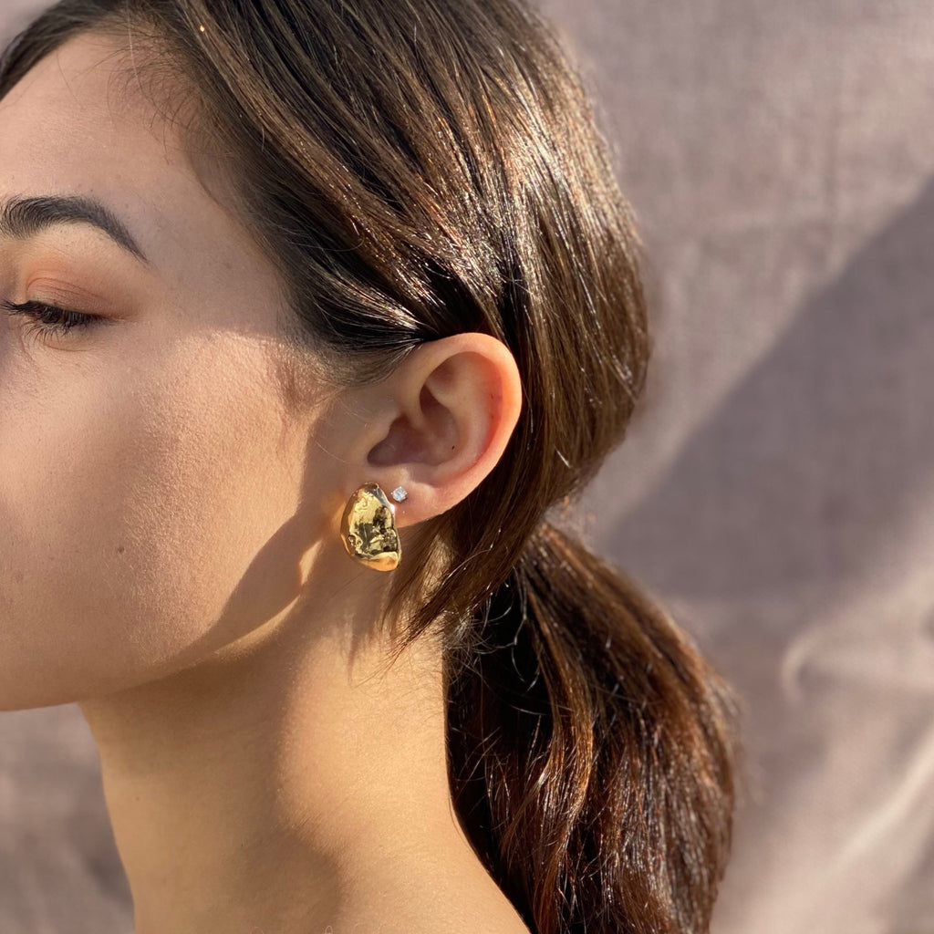 large bold gold earrings. Sculptural studs by desideri design jewelry