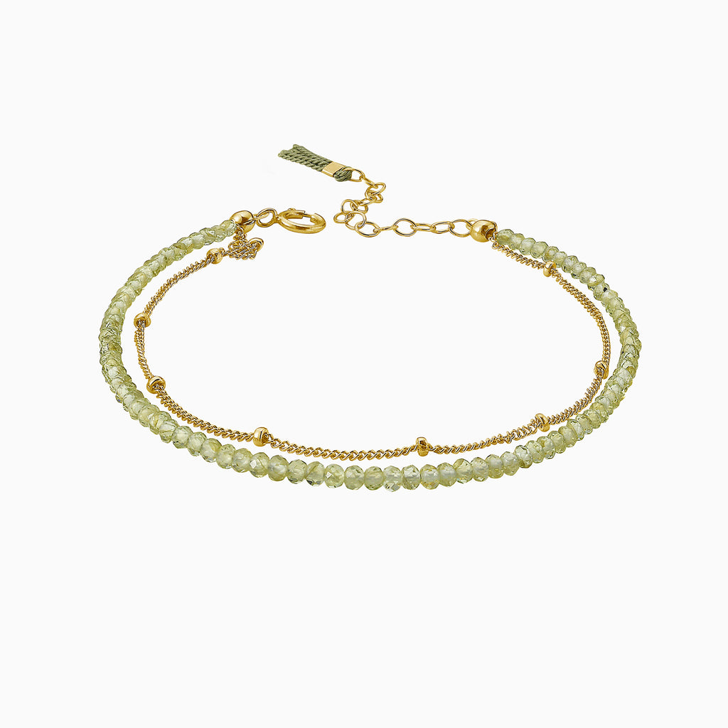 Gold and light green peridot beads by Desideri design. Adjustable