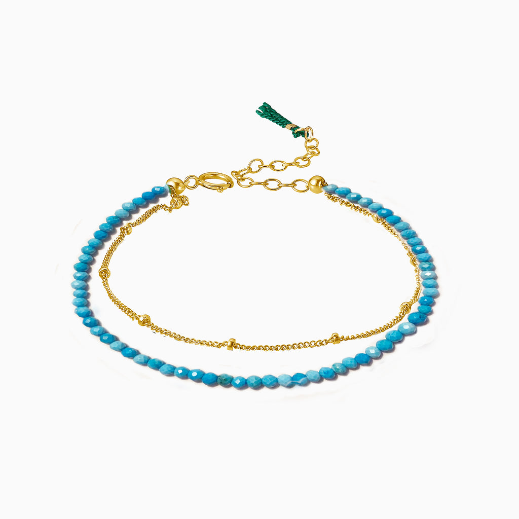 turquoise bracelet with gold chain and green tassel