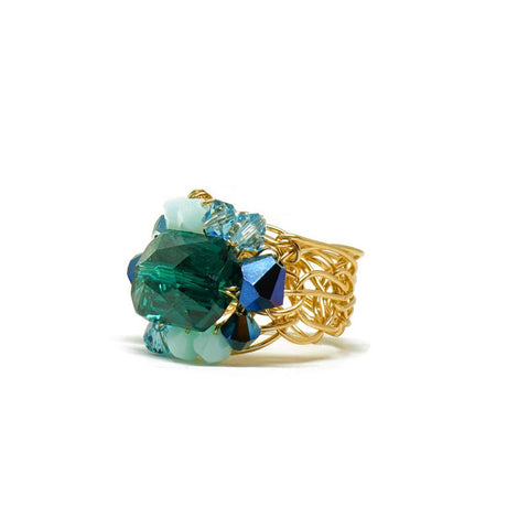 A gold-filled wire band ring with emerald green and blue colored Austrian crystals.
