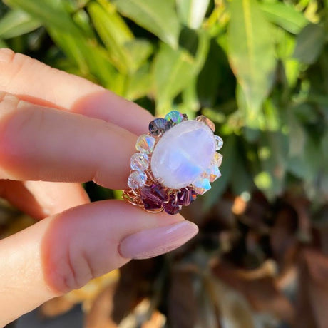 Unique Rainbow moonstone ring with delicate crystals details. rose gold.