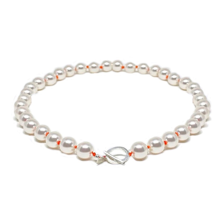 Pearls and orange knots necklace with silver clasp.